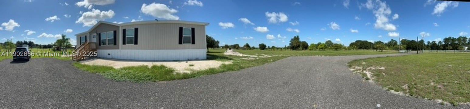 1250 Homestead Avenue Clewiston, FL 33440 - Photo 4 of 32 a view of a house with a yard and tree s