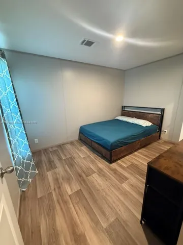 a room with wooden floor and furniture