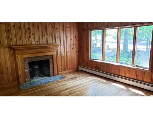 79 Ellis Road Westminster, MA 01473 - Photo 8 of 10 a view of an empty room with wooden floor fireplace and a window