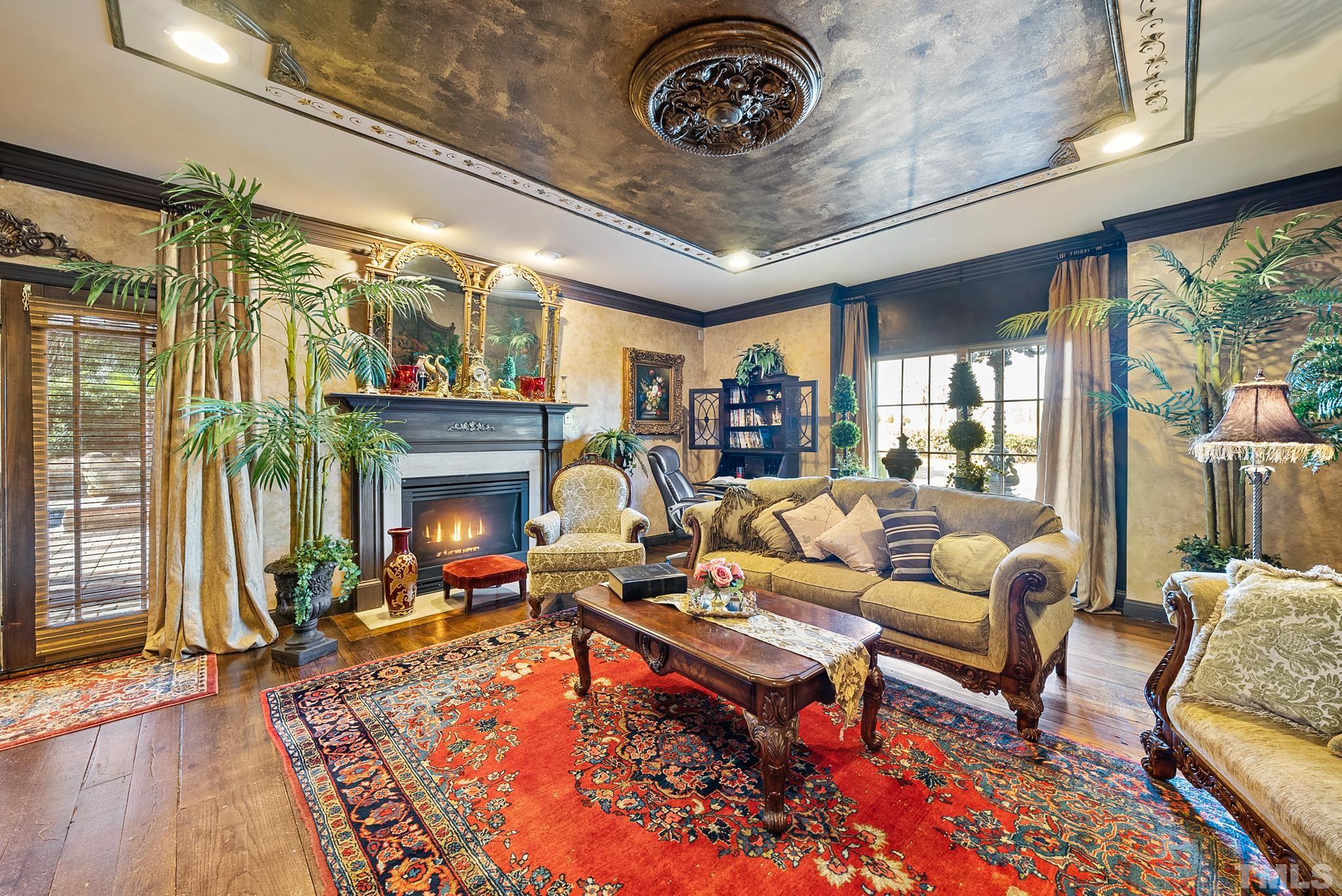 104 Pope Lake Road Angier, NC 27501 - Photo 13 of 49 a living room with furniture a fireplace and a floor to ceiling window