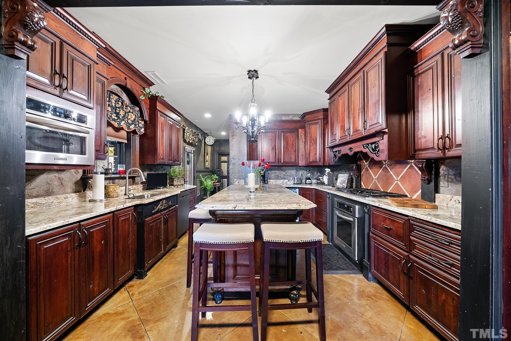 104 Pope Lake Road Angier, NC 27501 - Photo 18 of 49 a kitchen with stainless steel appliances granite countertop a stove a sink dishwasher and cabinets with wooden floor
