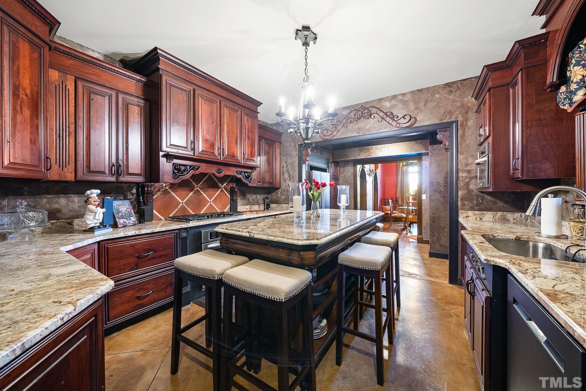 104 Pope Lake Road Angier, NC 27501 - Photo 20 of 49 a kitchen with granite countertop a table chairs stove and cabinets
