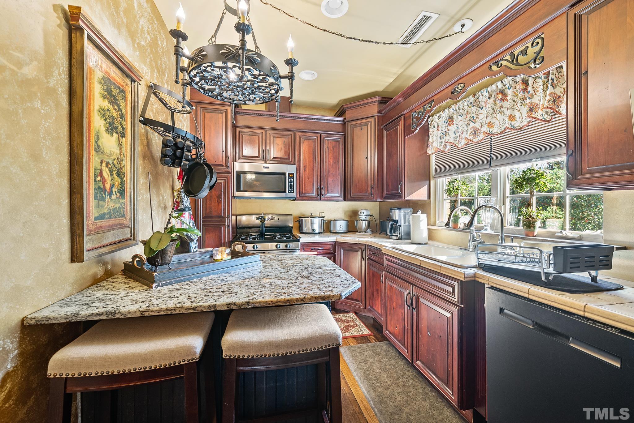 104 Pope Lake Road Angier, NC 27501 - Photo 35 of 49 a kitchen with stainless steel appliances granite countertop a sink stove and cabinets