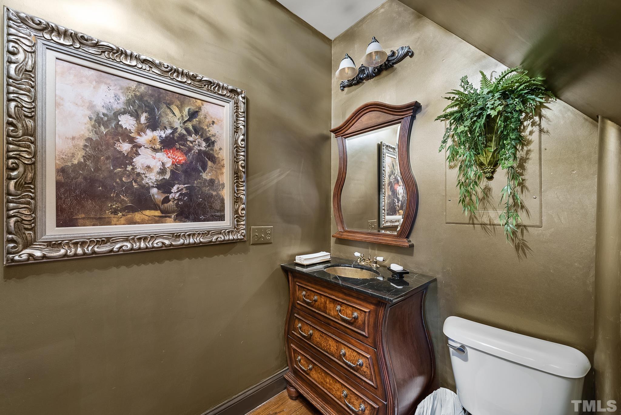 104 Pope Lake Road Angier, NC 27501 - Photo 40 of 49 a bathroom with a toilet a sink and mirror