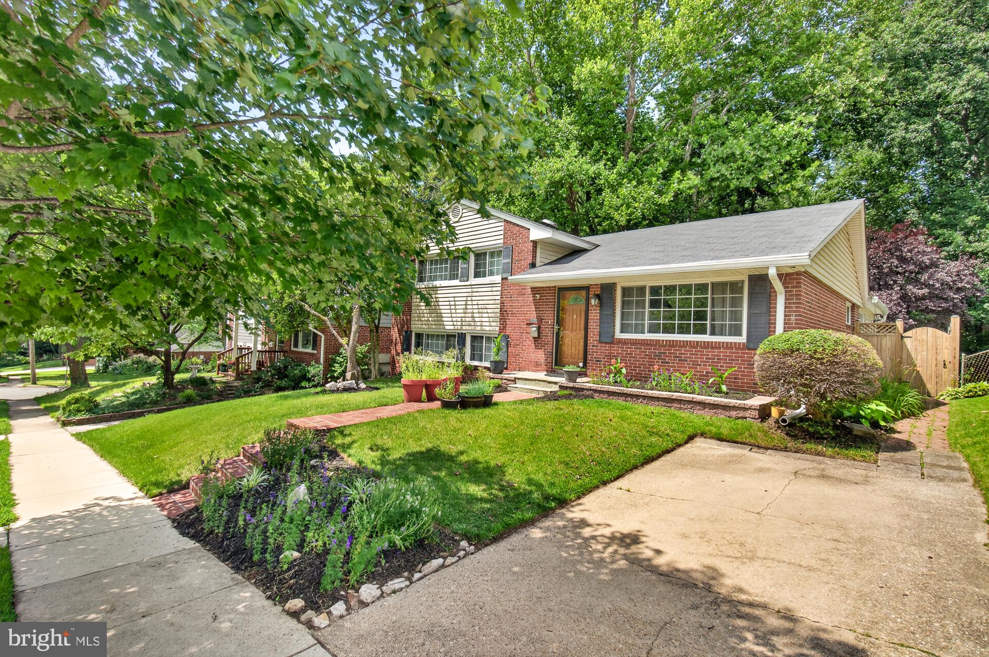 10202 Leslie Street Silver Spring, MD 20910 - Photo 2 of 44 Charming brick home with lush greenery.