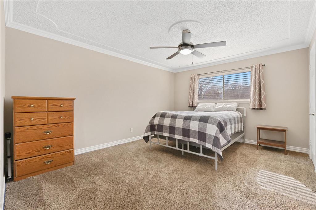 7636 Castillo Road Fort Worth, TX 76112 - Photo 12 of 28 a bedroom with a bed and a dresser