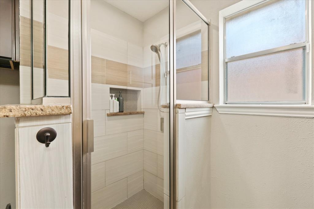 7636 Castillo Road Fort Worth, TX 76112 - Photo 15 of 28 a bathroom with a shower and a mirror