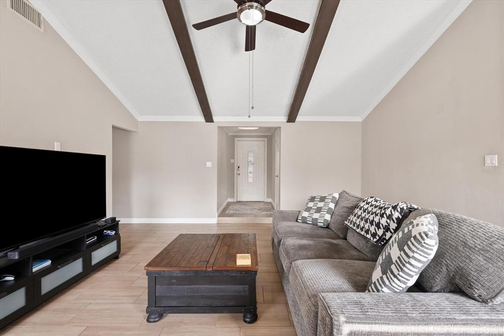 7636 Castillo Road Fort Worth, TX 76112 - Photo 5 of 28 a living room with furniture and a flat screen tv