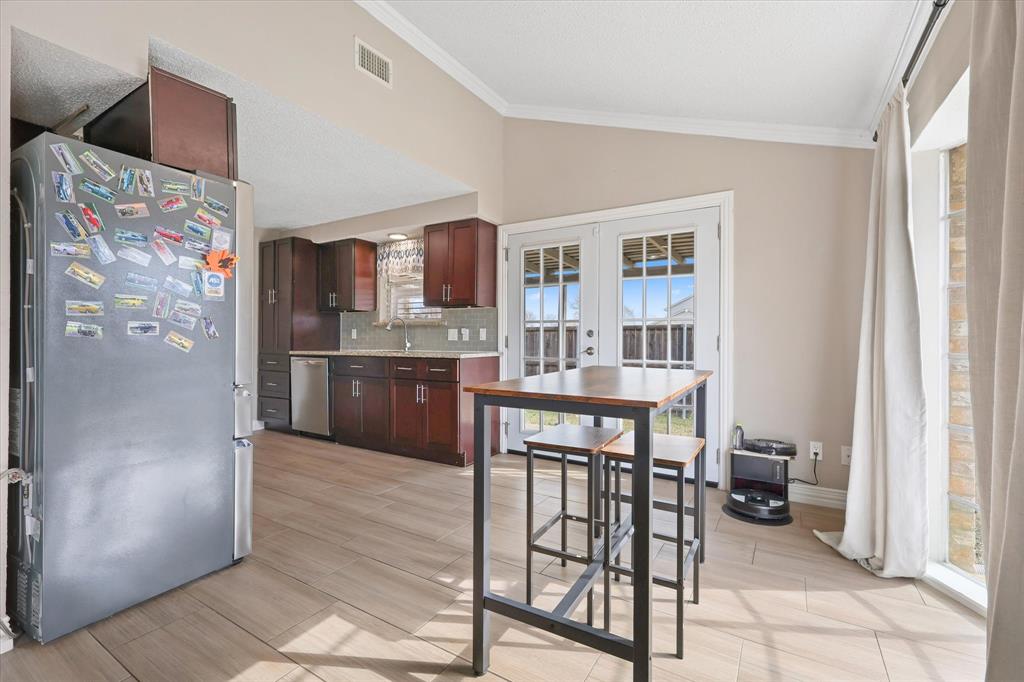 7636 Castillo Road Fort Worth, TX 76112 - Photo 7 of 28 a kitchen with stainless steel appliances a refrigerator and a stove top oven