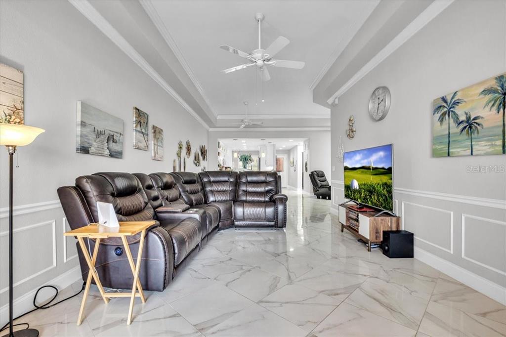 1260 Rio De Janeiro Avenue, Unit 102 Punta Gorda, FL 33983 - Photo 9 of 46 a living room with furniture and a flat screen tv