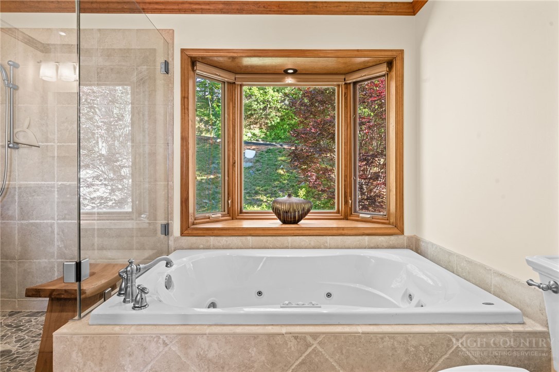 331 Alpine Road Blowing Rock, NC 28605 - Photo 29 of 50 a bathroom with a bathtub and a shower