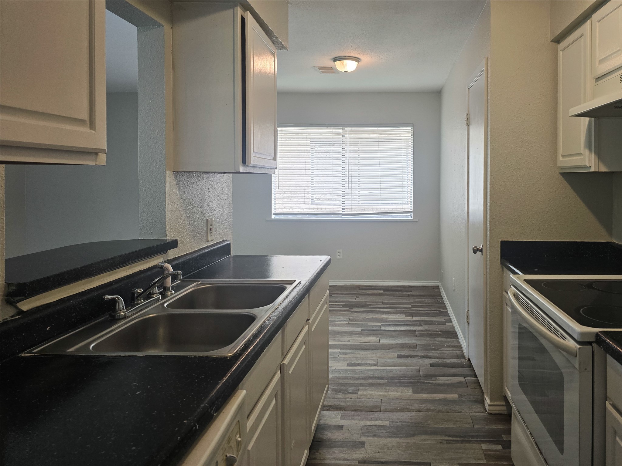 396 Duroux Road, Unit B La Marque, TX 77568 - Photo 1 of 9 a kitchen that has a sink and a stove