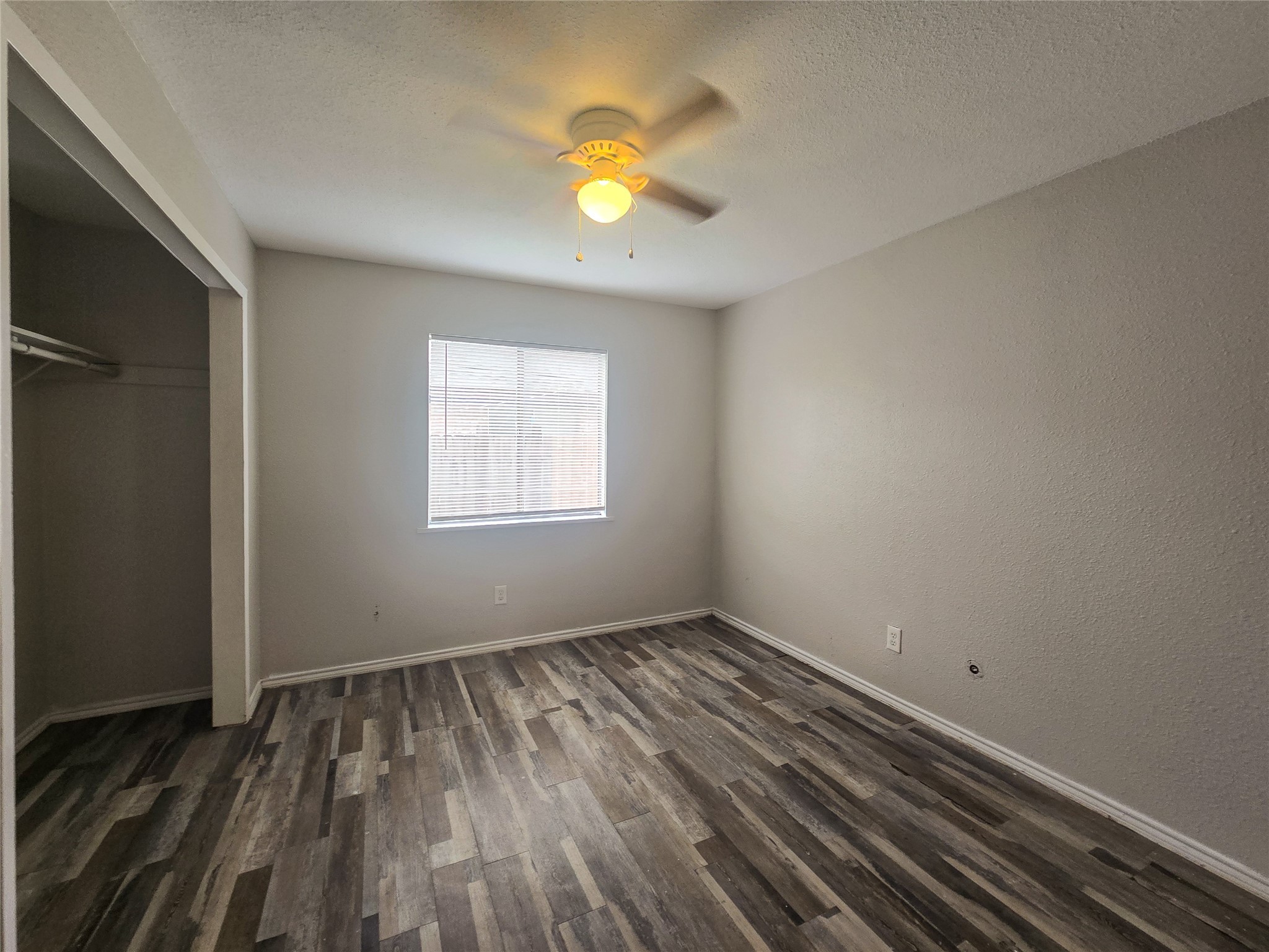 396 Duroux Road, Unit B La Marque, TX 77568 - Photo 5 of 9 a view of an empty room with wooden floor and a window