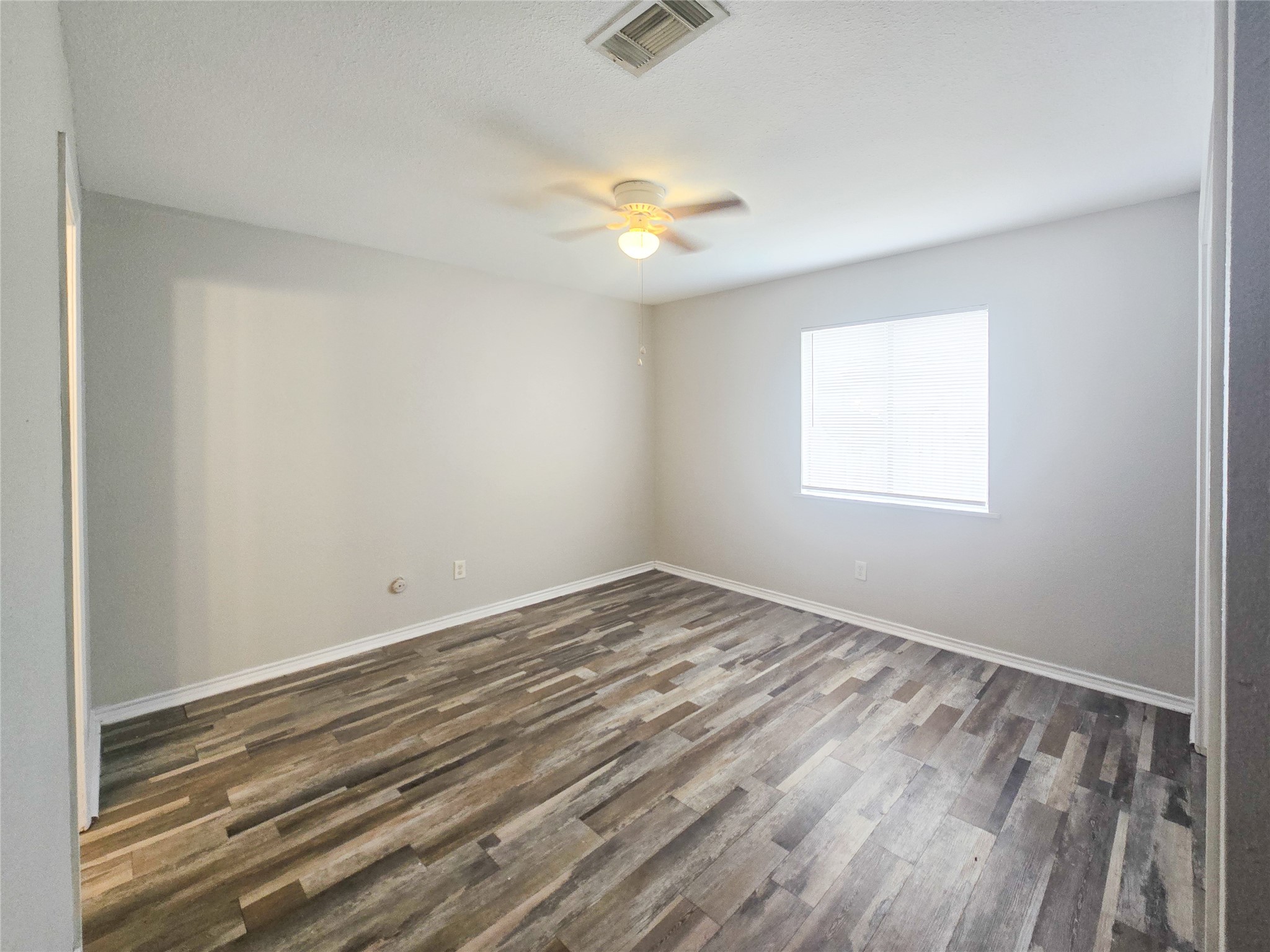 396 Duroux Road, Unit B La Marque, TX 77568 - Photo 7 of 9 wooden floor in an empty room with a window