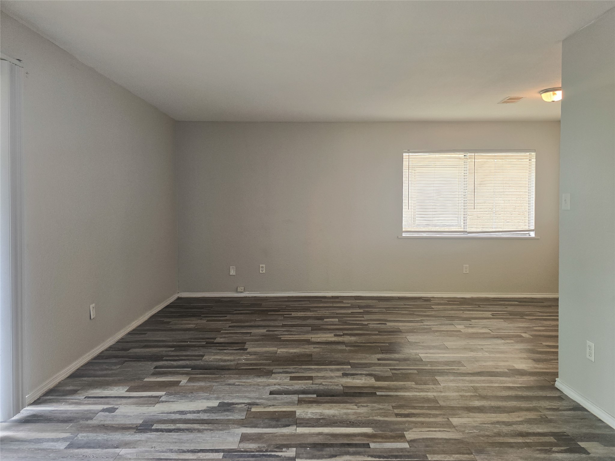 396 Duroux Road, Unit B La Marque, TX 77568 - Photo 9 of 9 a view of an empty room with wooden floor and a window