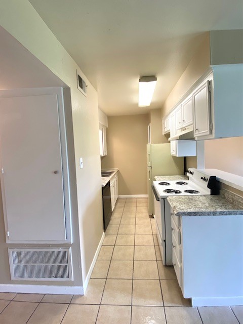 3206 Lobit Drive, Unit 14 Dickinson, TX 77539 - Photo 2 of 11 a kitchen with stainless steel appliances granite countertop a stove a sink and a refrigerator