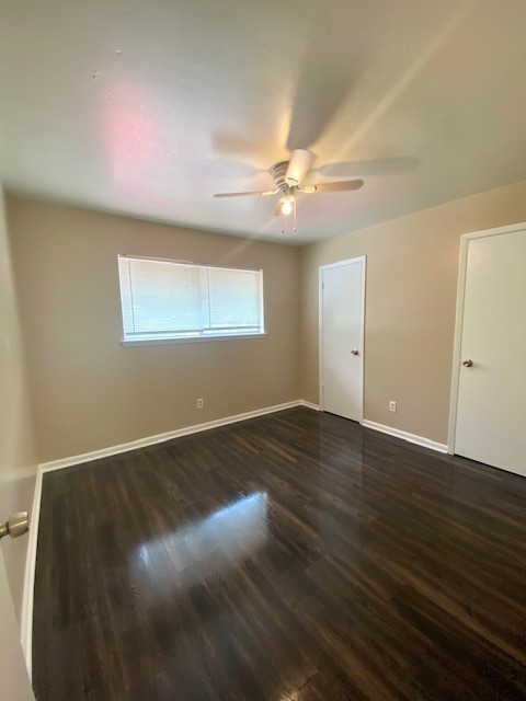 3206 Lobit Drive, Unit 14 Dickinson, TX 77539 - Photo 5 of 11 an empty room with wooden floor chandelier fan and windows