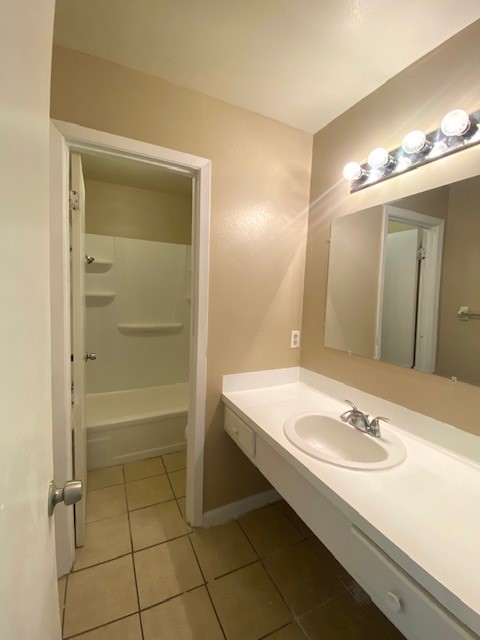 3206 Lobit Drive, Unit 14 Dickinson, TX 77539 - Photo 7 of 11 a bathroom with a sink a toilet and shower