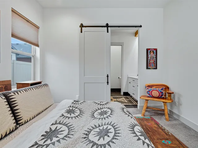 a bedroom with a bed and a window