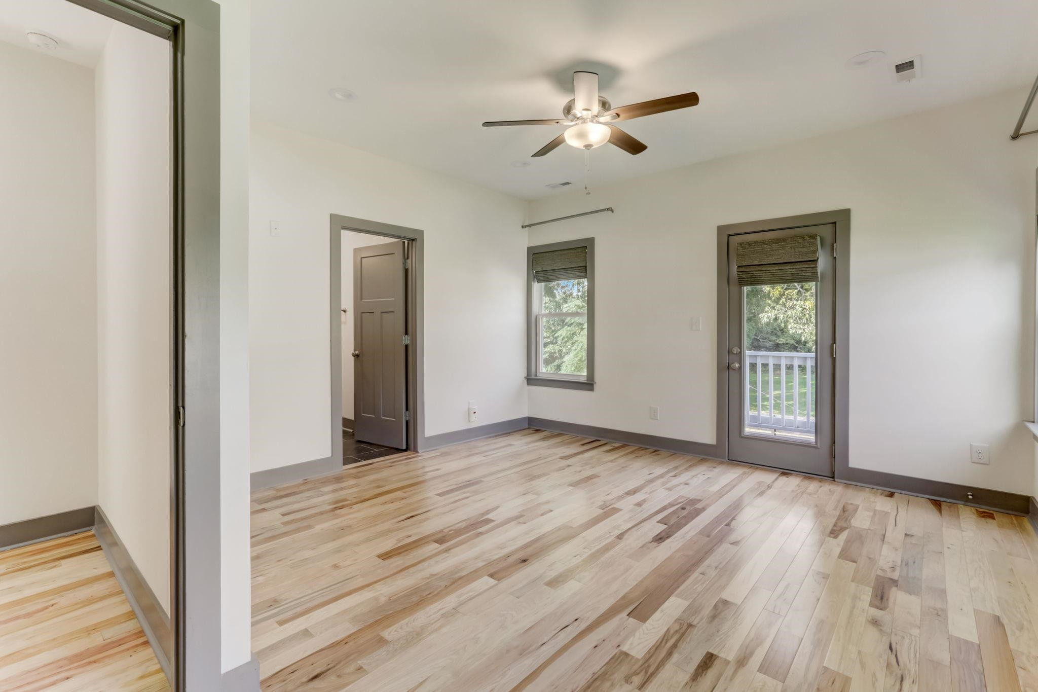 7 Hill Street Raleigh, NC 27610 - Photo 12 of 25 a view of an empty room with wooden floor and a window