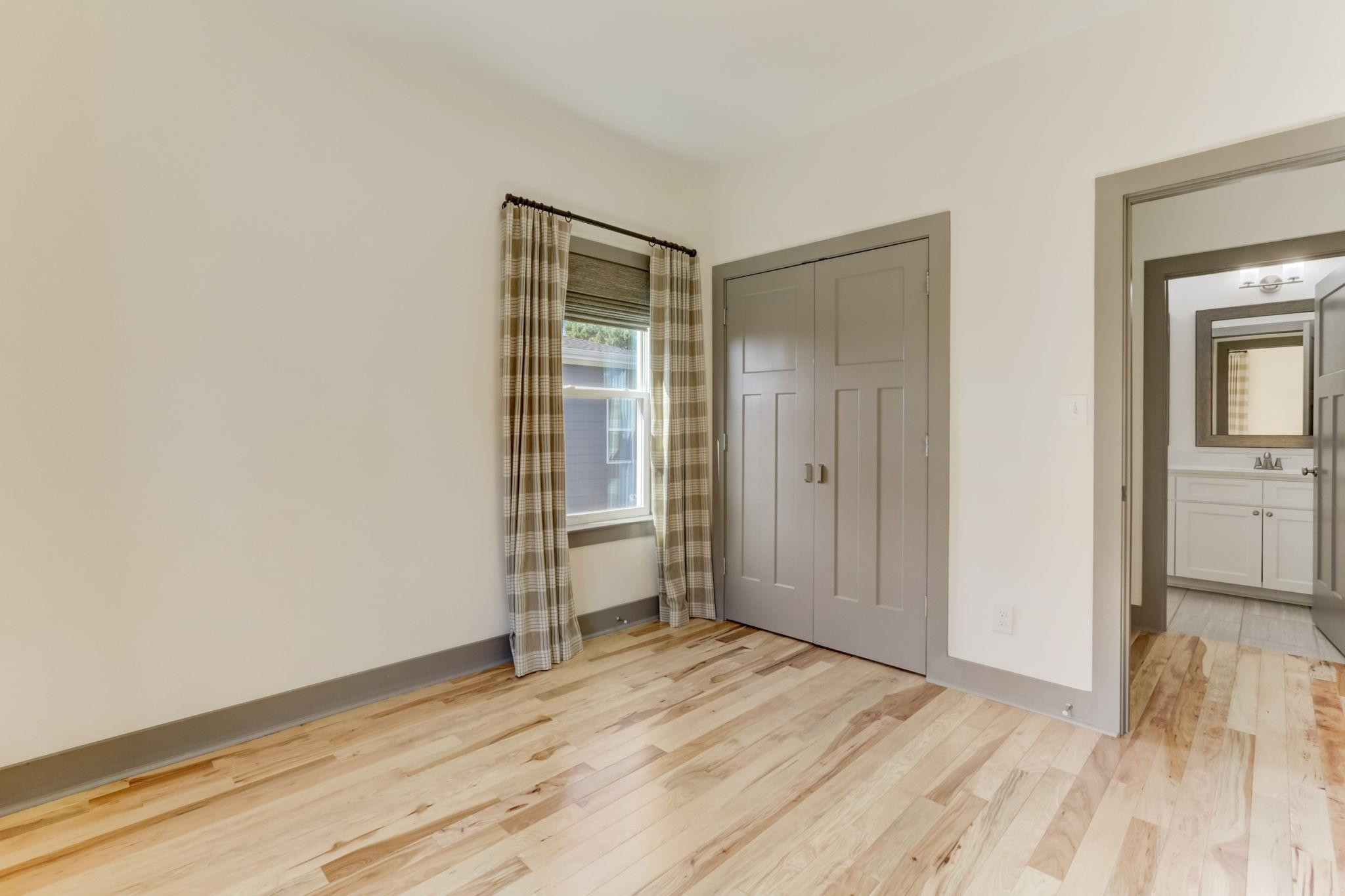 7 Hill Street Raleigh, NC 27610 - Photo 18 of 25 a view of a room with wooden floor and a bathroom