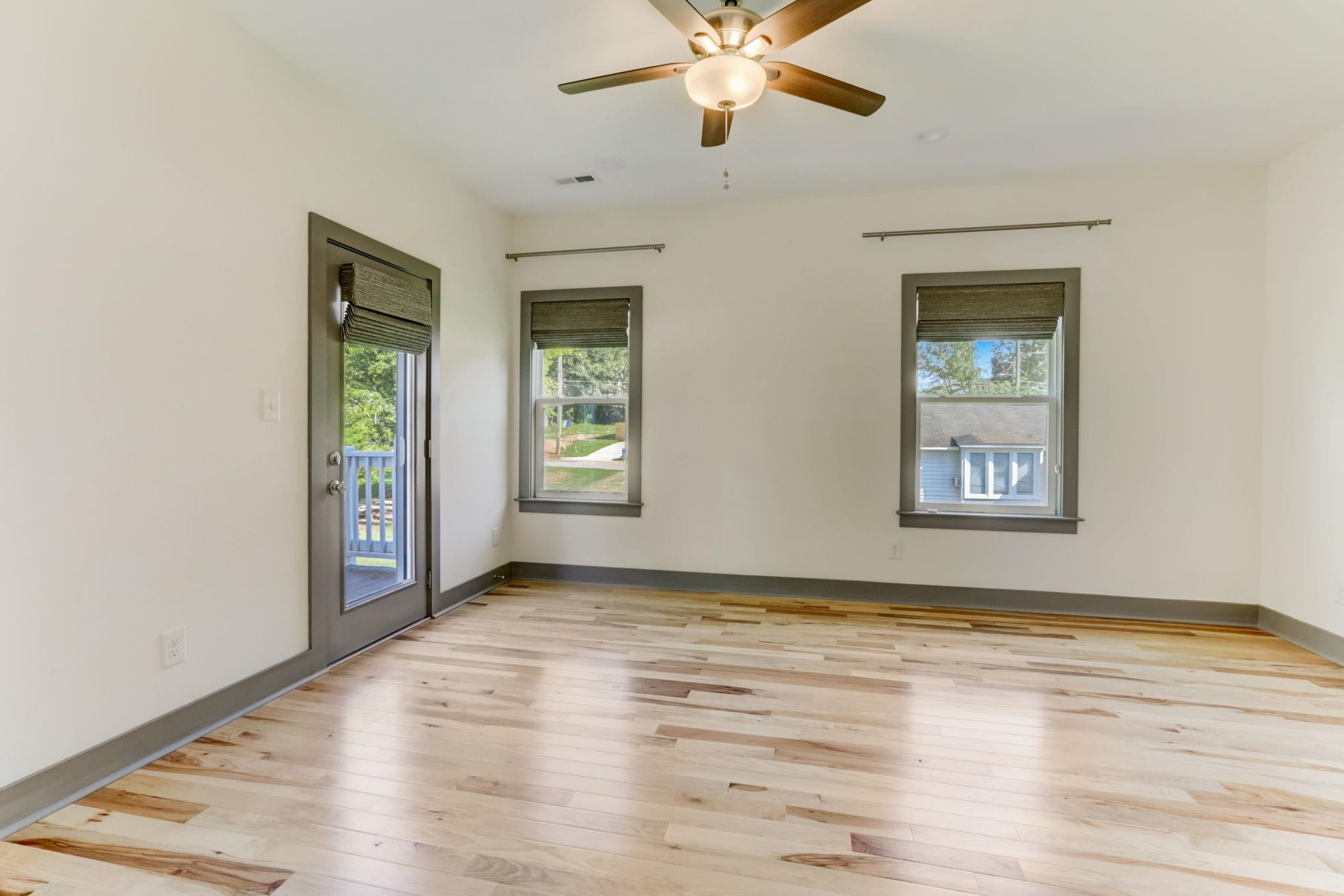 7 Hill Street Raleigh, NC 27610 - Photo 21 of 25 a view of an empty room with wooden floor and a window