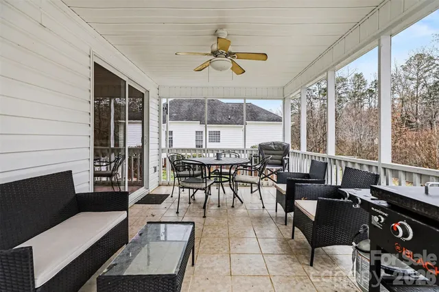 a dining room with furniture a rug and a large window