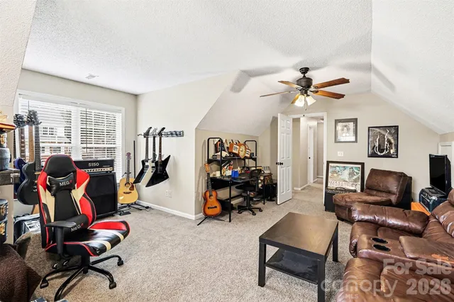 a view of a workspace with furniture and gym equipment
