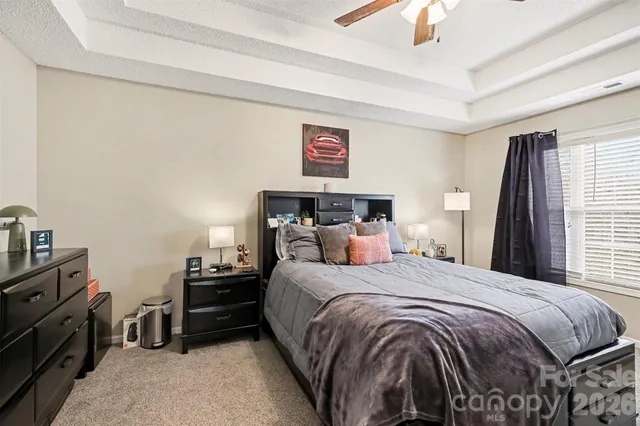 a bed sitting in a bedroom next to a window