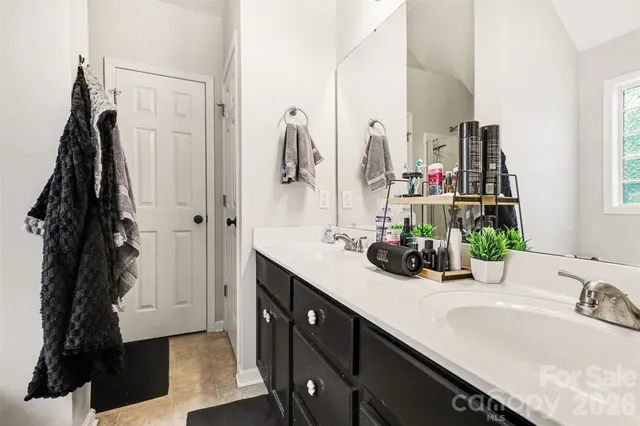 a bathroom with a double vanity sink and a mirror