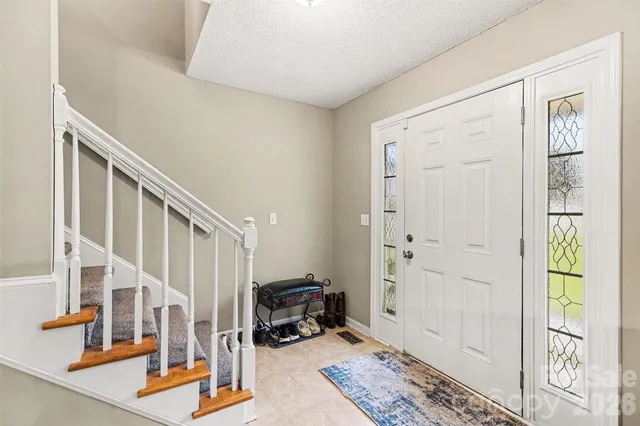a view of a hallway with workspace and living room