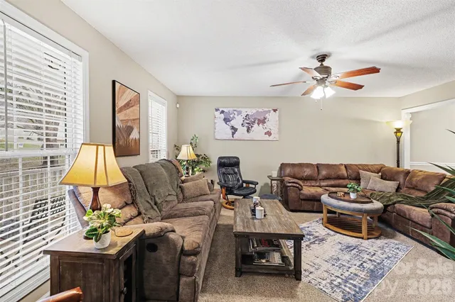 a living room with furniture a couch and a chandelier