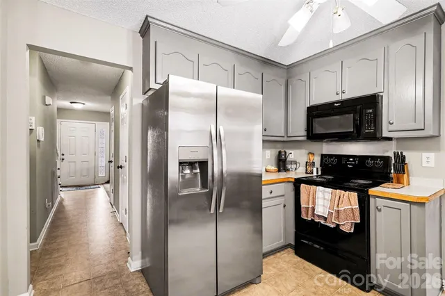 a kitchen with granite countertop a refrigerator and a sink