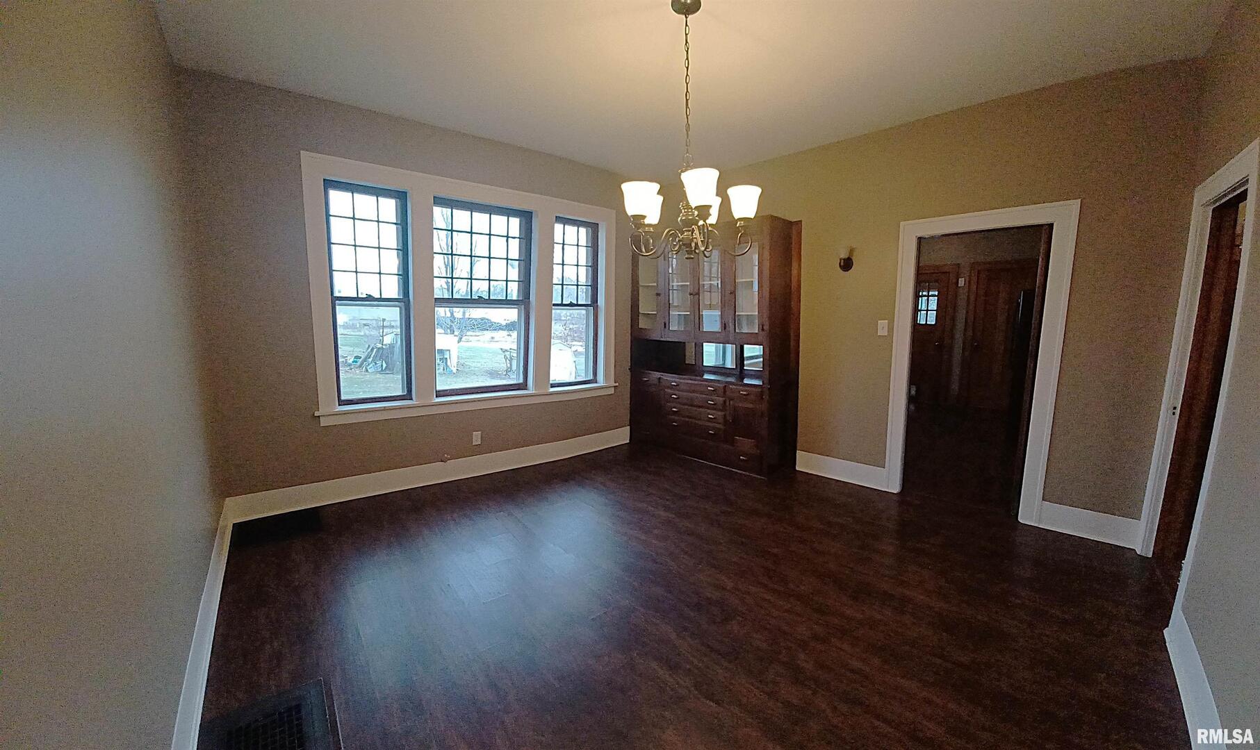 125 A Street Buda, IL 61314 - Photo 12 of 29 an empty room with wooden floor and windows