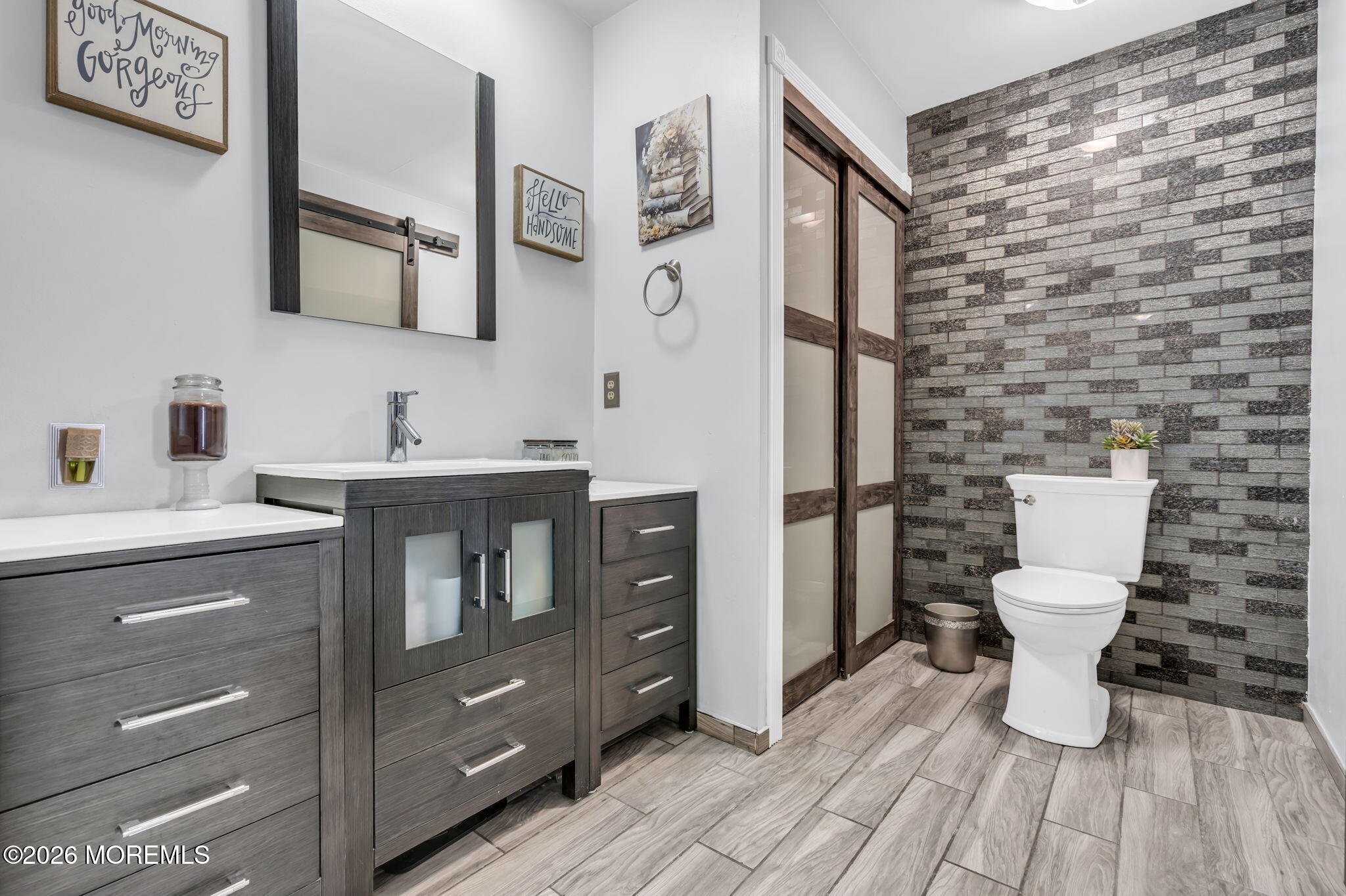 21 Ryan Road Marlboro, NJ 07746 - Photo 23 of 56 a bathroom with a toilet a sink and mirror