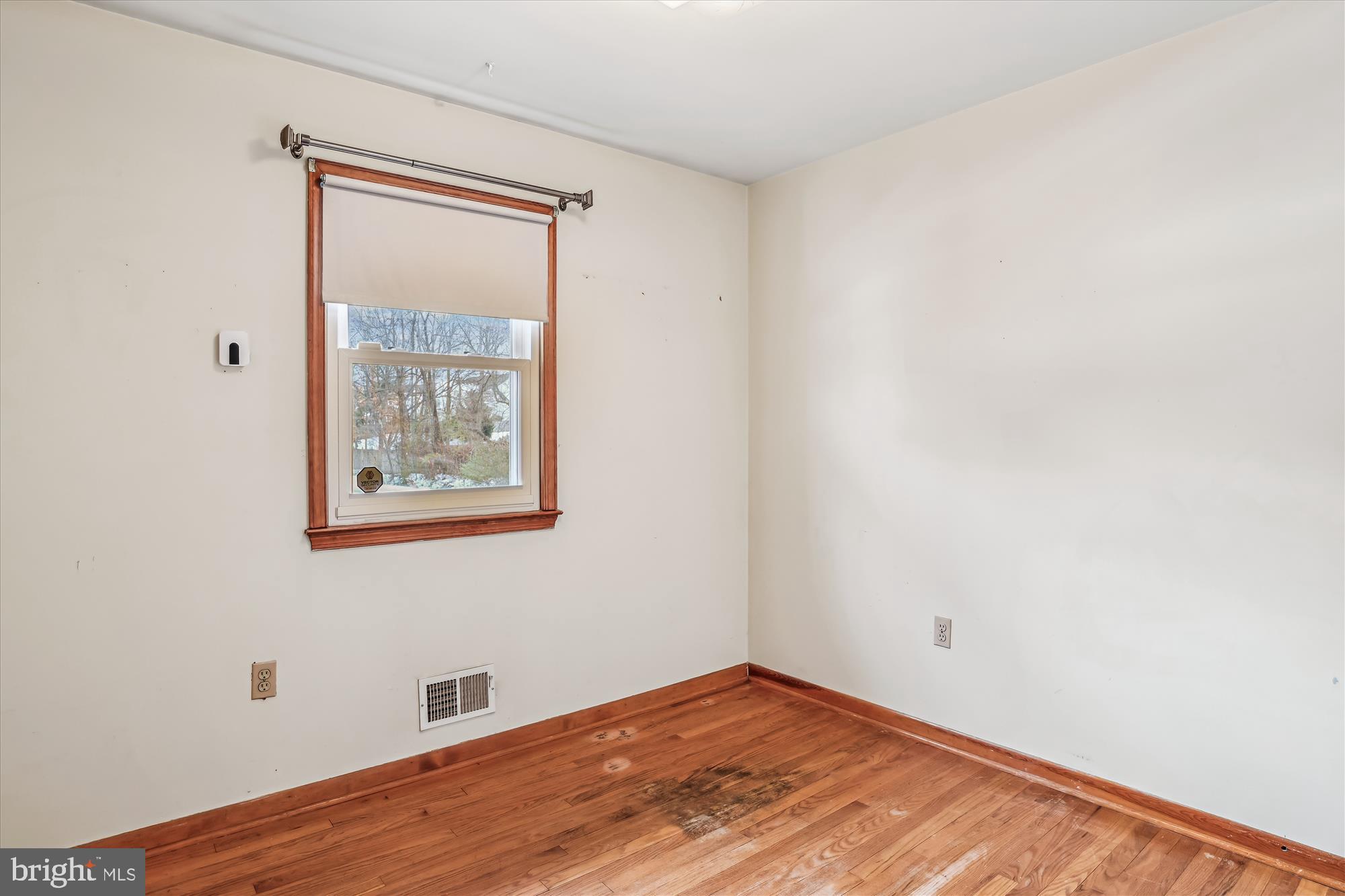 1418 Larch Road Severn, MD 21144 - Photo 26 of 36 a view of an empty room with wooden floor and a window