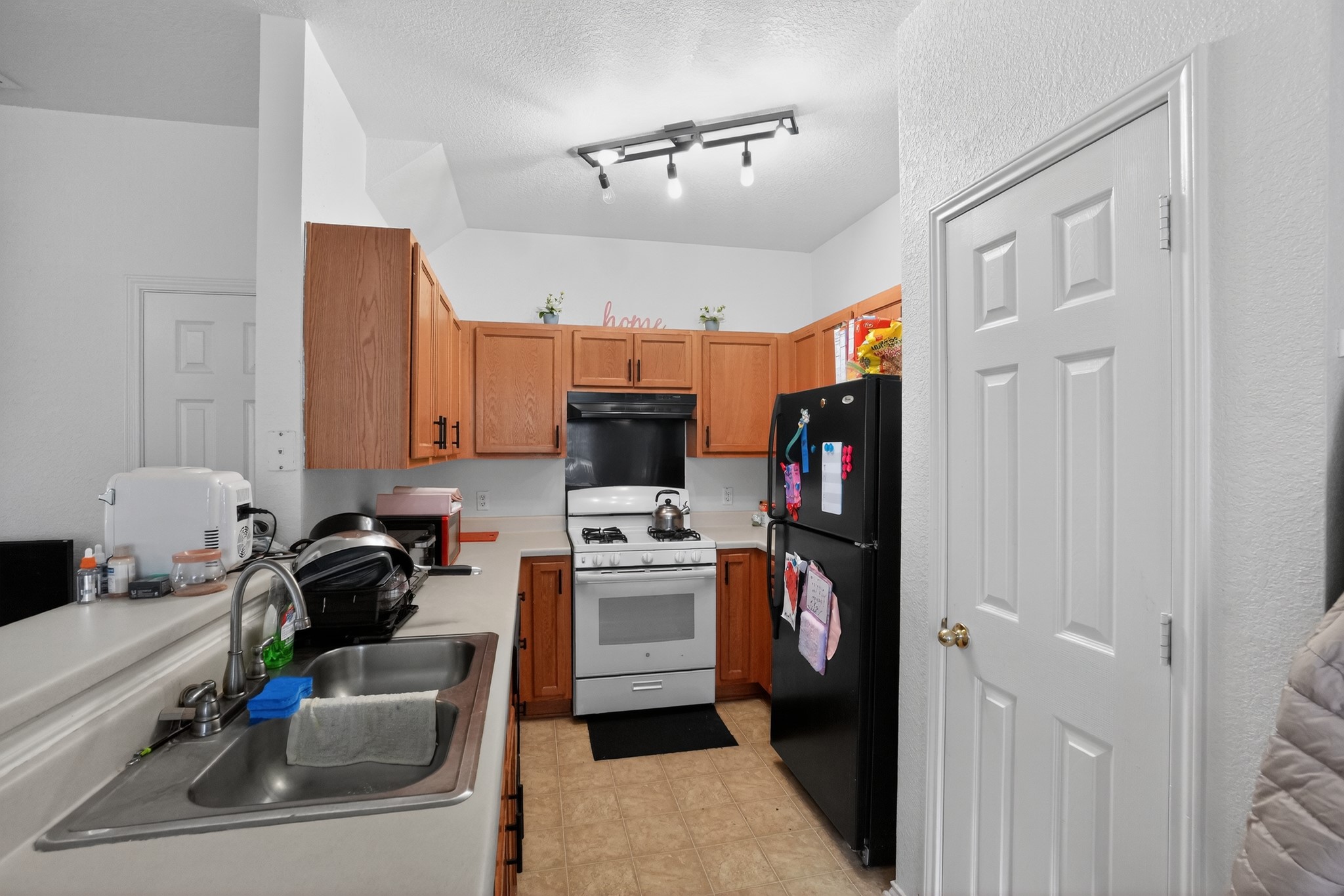 13808 Harris Ridge Boulevard Pflugerville, TX 78660 - Photo 34 of 40 a view of a kitchen with a sink and a refrigerator
