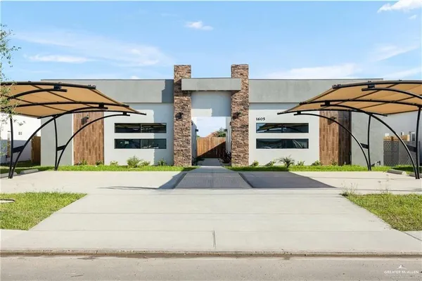 a front view of a house with a yard and table