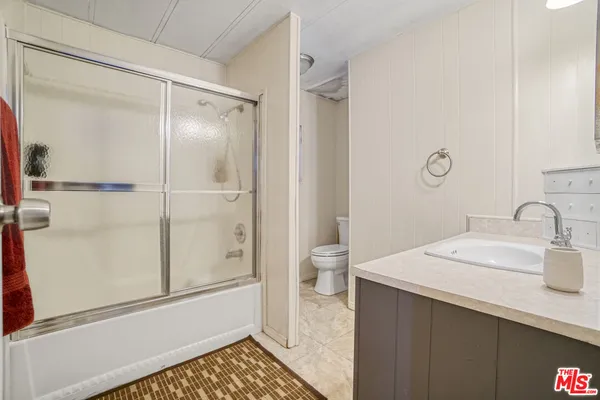 a bedroom with furniture and a flat screen tv