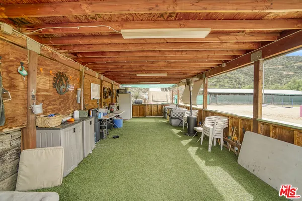 a front view of a house with outdoor seating