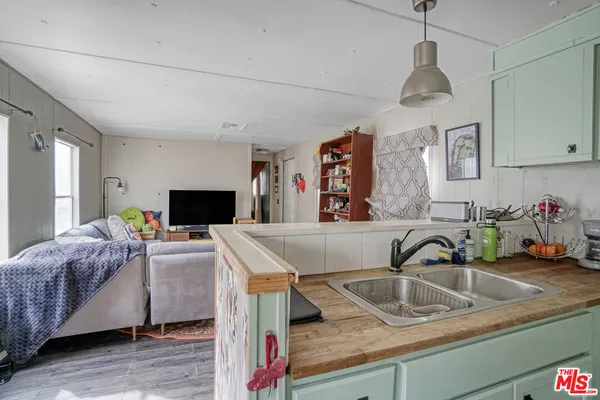 a bathroom with a granite countertop sink a mirror and shower