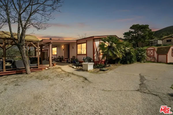 a view of a backyard with sitting area
