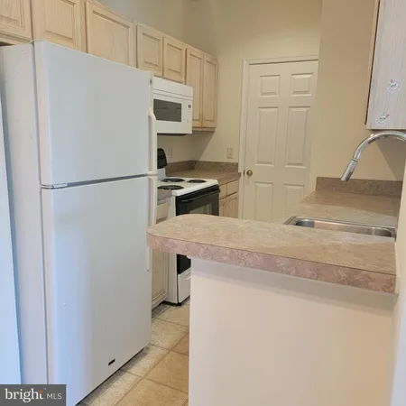 a white refrigerator freezer sitting inside of a kitchen
