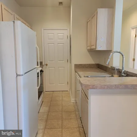 a kitchen with a refrigerator and a sink