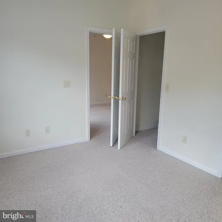 an empty room with closet area