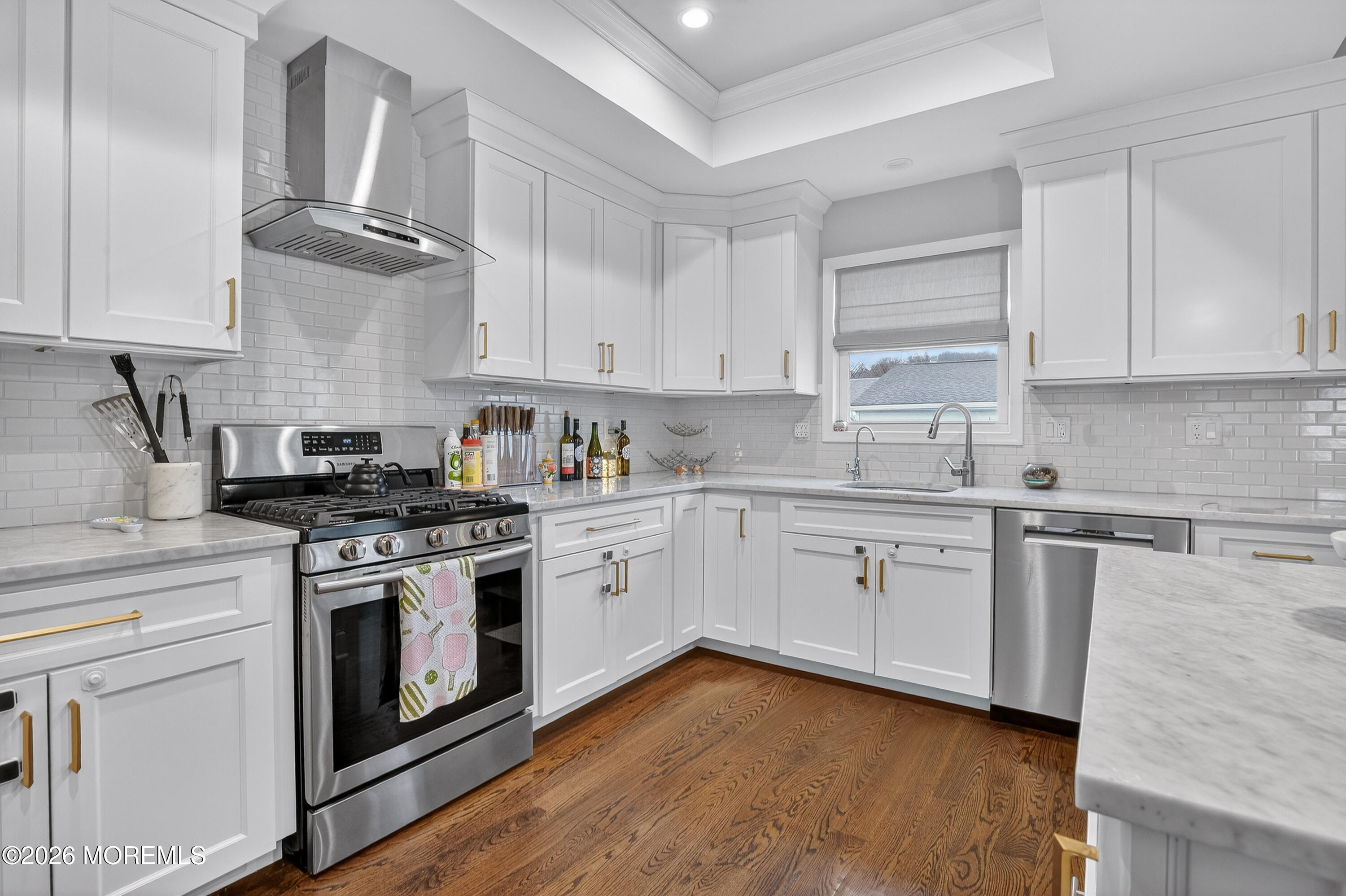27 5th Street Highlands, NJ 07732 - Photo 7 of 62 a kitchen with cabinets stainless steel appliances and wooden floor