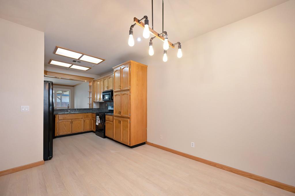 9594 Prost Court Elk Grove, CA 95758 - Photo 11 of 46 a kitchen with refrigerator and window