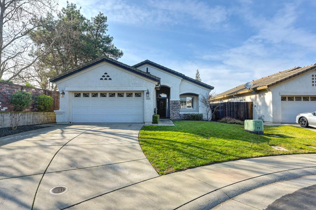 9594 Prost Court Elk Grove, CA 95758 - Photo 2 of 46 a front view of a house with a yard and garage