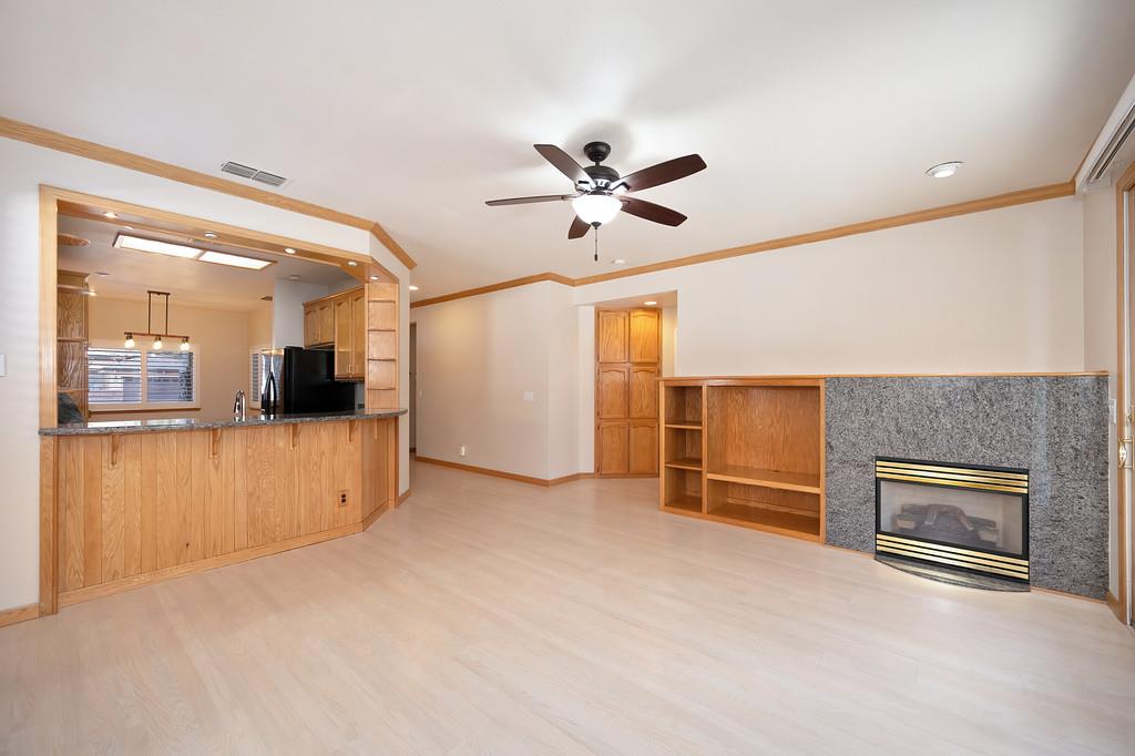 9594 Prost Court Elk Grove, CA 95758 - Photo 21 of 46 wooden floor in an empty room with a fireplace