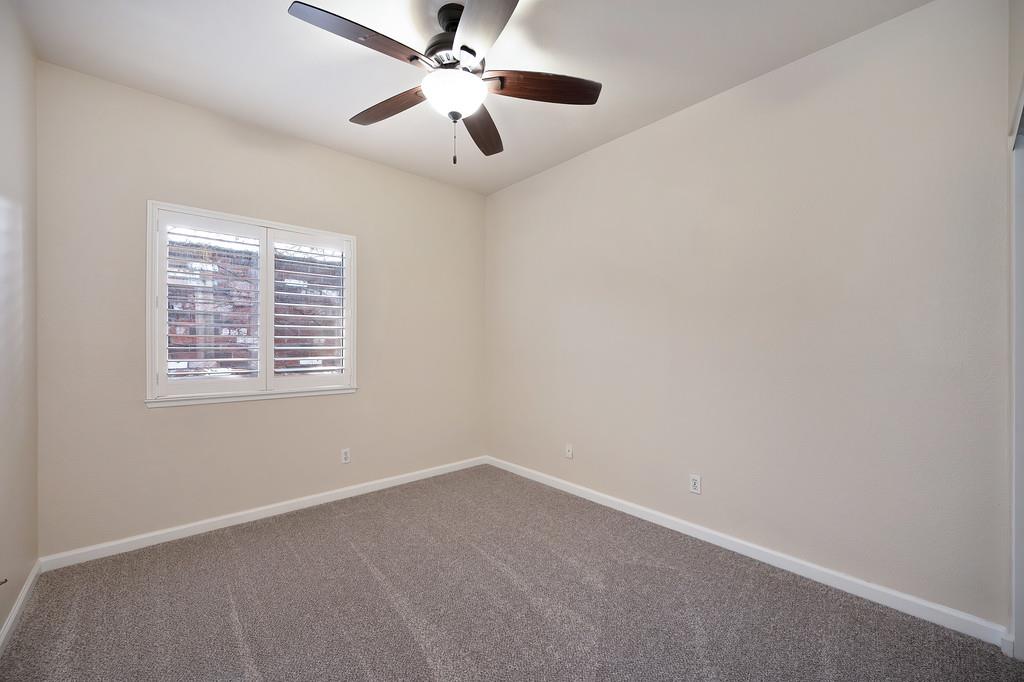 9594 Prost Court Elk Grove, CA 95758 - Photo 33 of 46 an empty room with a window and a fan